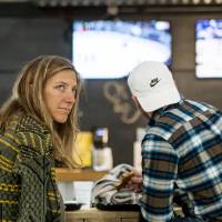 Two alumni drink, eat and socialize at the Fowling Fun Event